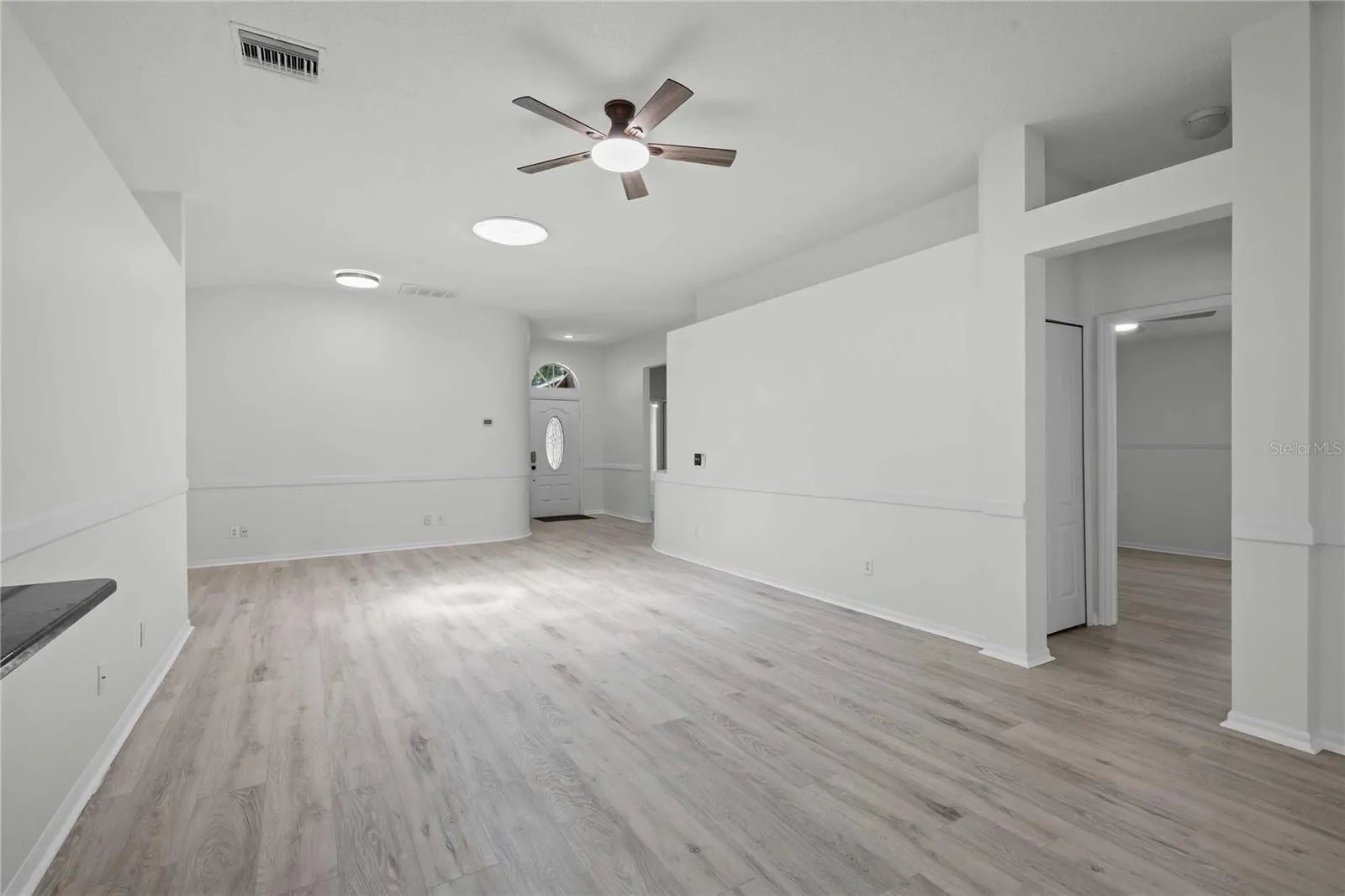 View of Living Room, Entrance to Bedroom, and Entryway - New Flooring, New Ceiling Fan, Professional Paint