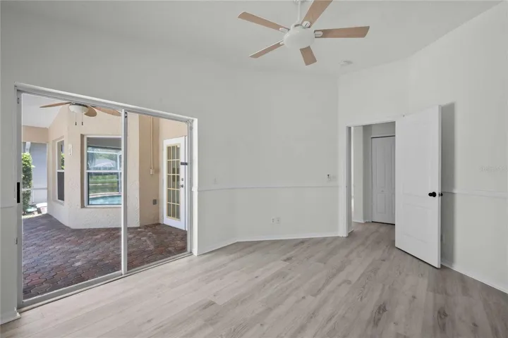 Primary Room - New Flooring, New Professional Paint, New Ceiling Fan, Sliding Glass Doors exit to Lanai & Pool Area