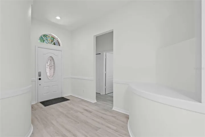 View of Entry and Hallway to Full Bathroom and Bedrooms - New Flooring, New Professional Paint.