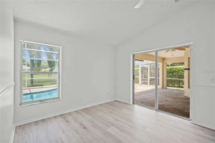 Primary Room - New Flooring, New Professional Paint, New Ceiling Fan, Sliding Glass Doors exit to Lanai & Pool Area