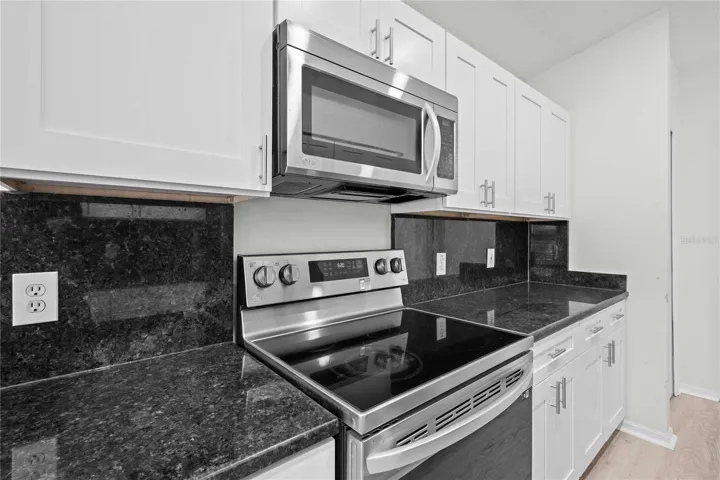 View of Living & Kitchen Area. New Kitchen Cabinets, New Flooring, New Recessed Lighting, New Ceiling Fans, and More!
