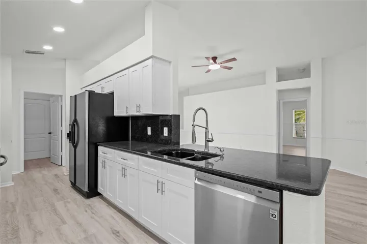 View of Living & Kitchen Area. New Kitchen Cabinets, New Flooring, New Recessed Lighting, New Ceiling Fans, Stainless Steel Appliances