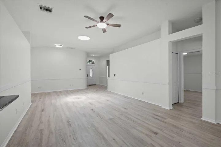 View of Living Room, Entrance to Bedroom, and Entryway - New Flooring, New Ceiling Fan, Professional Paint