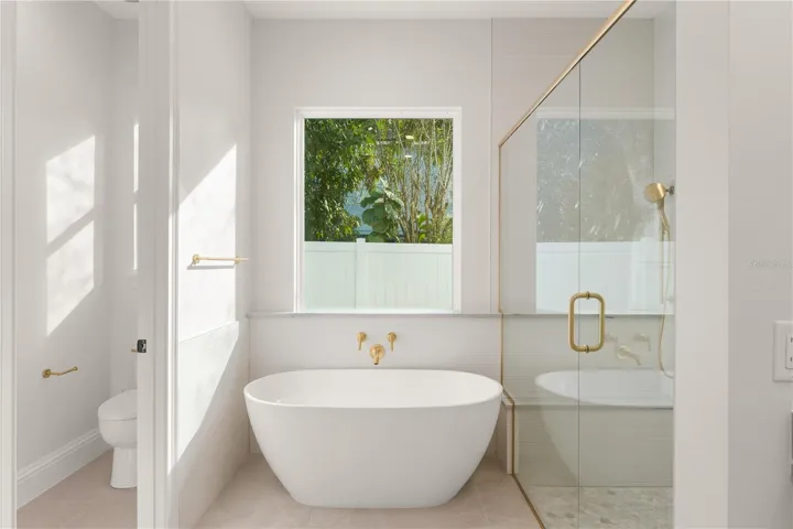 The primary bathroom offers a spa like retreat for the owners, which includes a relaxation tub, a large walk-in shower with double shower heads, a private water closet, a well appointed vanity area with double sinks and several drawers, as well as a linen closet for additional storage.