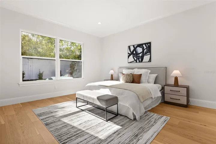 The primary suite has a beautiful view of the private backyard.