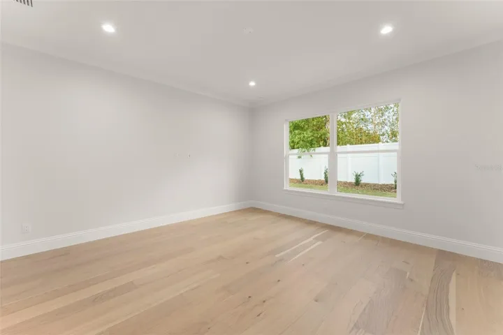 The primary suite has a beautiful view of the private backyard.