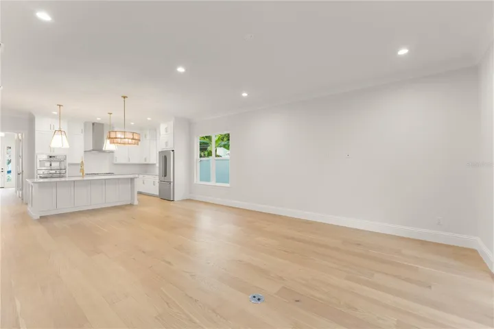 The engineered wood flooring adds warmth; the large baseboards, crown moulding and trim detail add rich finishing touches to this unique home.