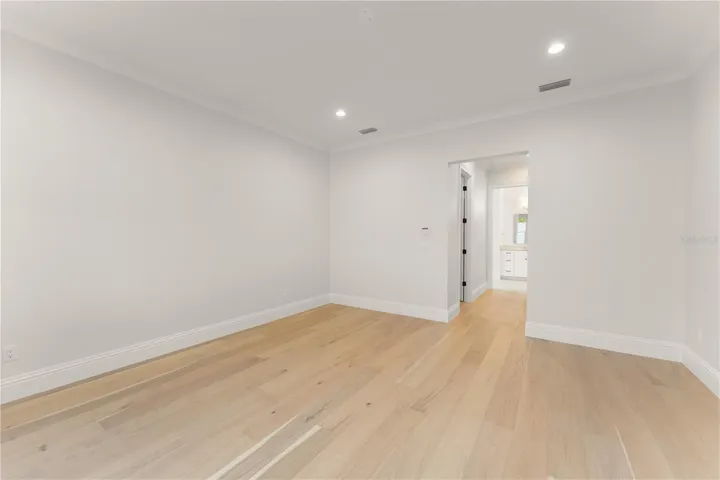 View from the primary bedroom, looking toward the double closets, into the primary bathroom.