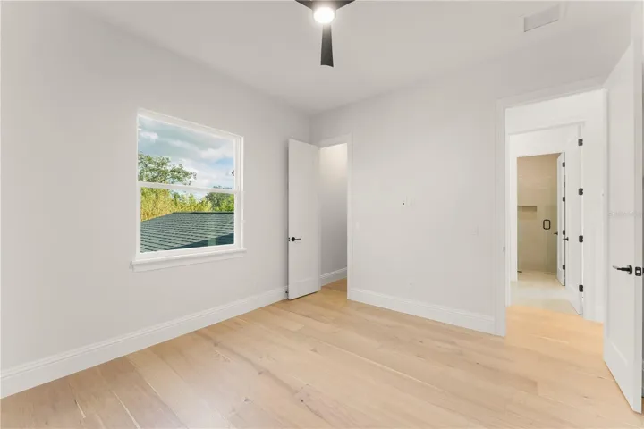 Bedroom 4 has a walk-in closet with built-in closet shelving and access to Bathroom 3 via the hallway.