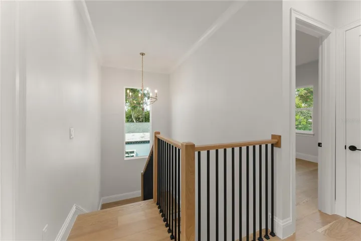 The wood stairway is accented by the wood handrailing with metal ballusters.