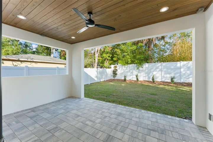 The large covered lanai has paver decking, a tongue & groove wood ceiling, it is pre-plumbed for a future summer kitchen.  The lanai opens up to a large PVC privacy fenced back and side yards.