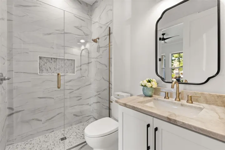 The stylish bathroom is located off the  study/bedroom 5. It showcases the timeless selections made by the Designer.