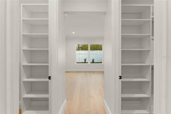 Double walk-in closets within the primary bedroom give the owners plenty of storage space.
