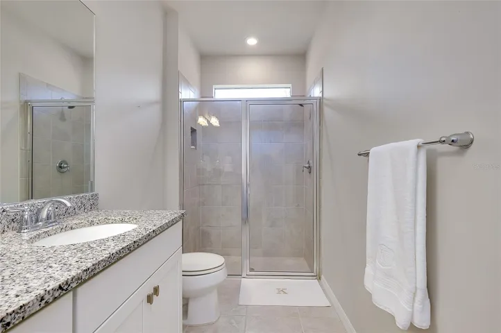 Granite counter tops, glass door to shower.