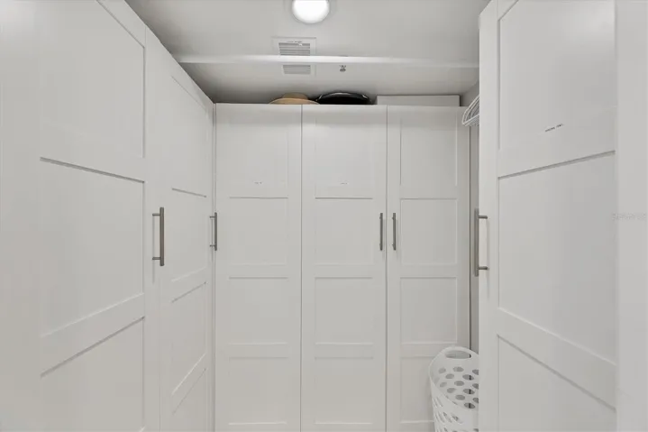 Master walk-in closet features custom cabinetry