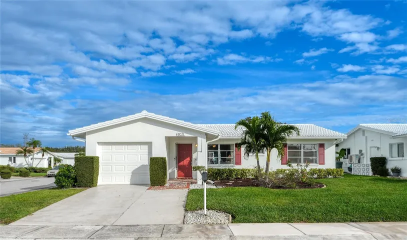 Wonderful curb appeal is this well-maintained home. The epitome of a Florida home.