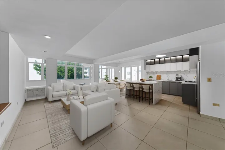 Great Room and Kitchen - This image has been virtually staged and features a conceptual kitchen remodel. The photo does not reflect the current state of the property.