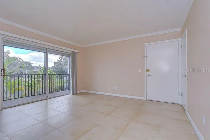 Light and bright open floor plan with neutral paint and ceramic tile flooring throughout