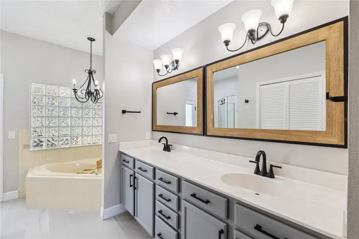 Primary Bathroom with double vanity, soak-in tub and separate shower
