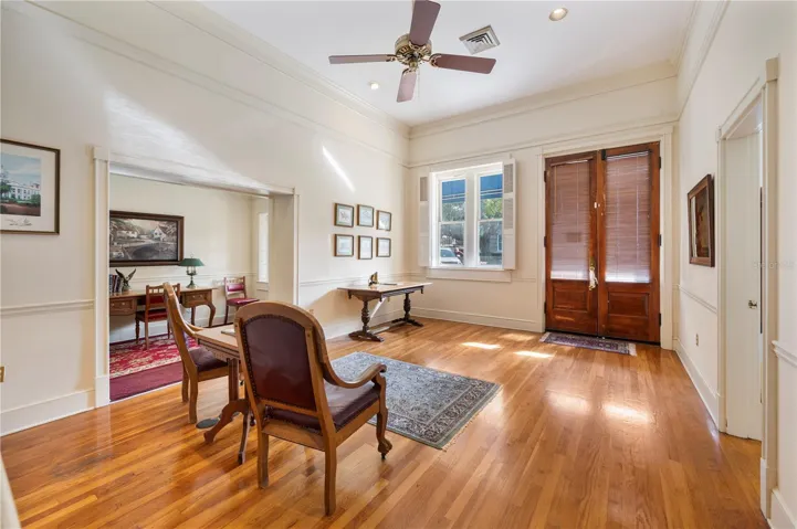 Original double doors grace the front entry, along with soaring ceilings, picture rail , tall base boards and hardwood flooring.
