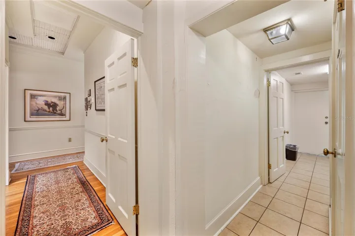 This view features the entrance to the kitchen and back out to the main office areas