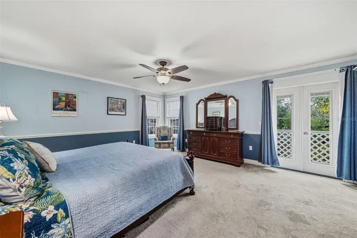 Upstairs primary suite with balcony overlooking pool