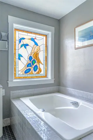 Stained glass window overlooking the tub