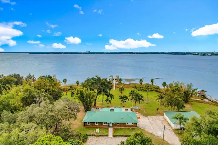 3.6 acres lot with 6 car detached garage on the right and main house with attached studio on the left