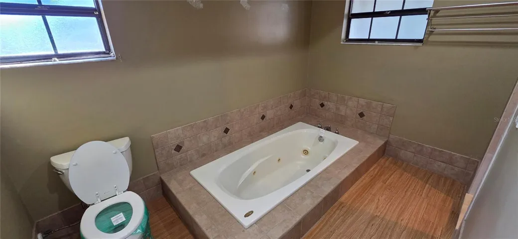 Separate Primary Bathroom with Toilet, Tub and Shower