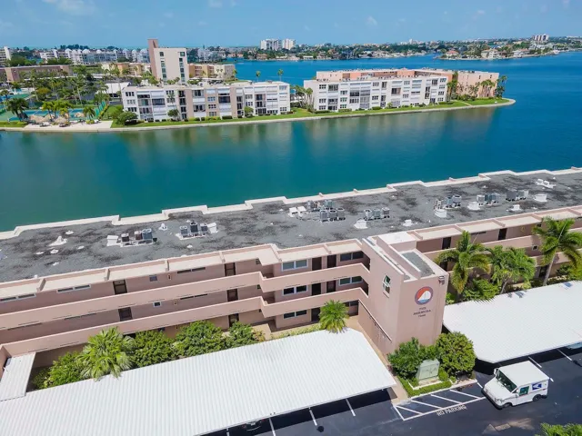 Front entry building . Water view from back of unit overlooks BOCA CIEGA BAY , and out to the GULF of MEXICO
