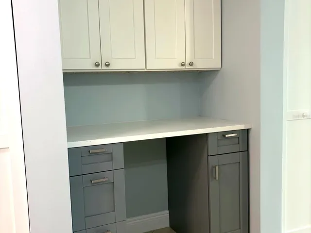 Desk dry bar off of kitchen for extra storage or workspace environment