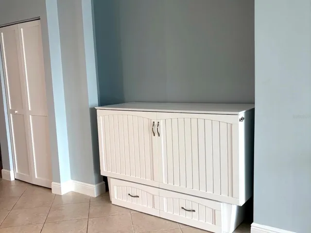 Murphy bed inside studio apartment pulls out to full bed