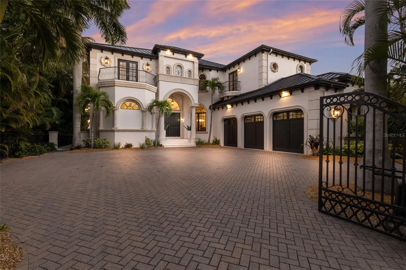 Gated entrance to paver driveway.