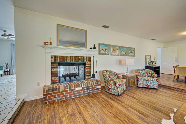 Wood burning fireplace open to the family room as well