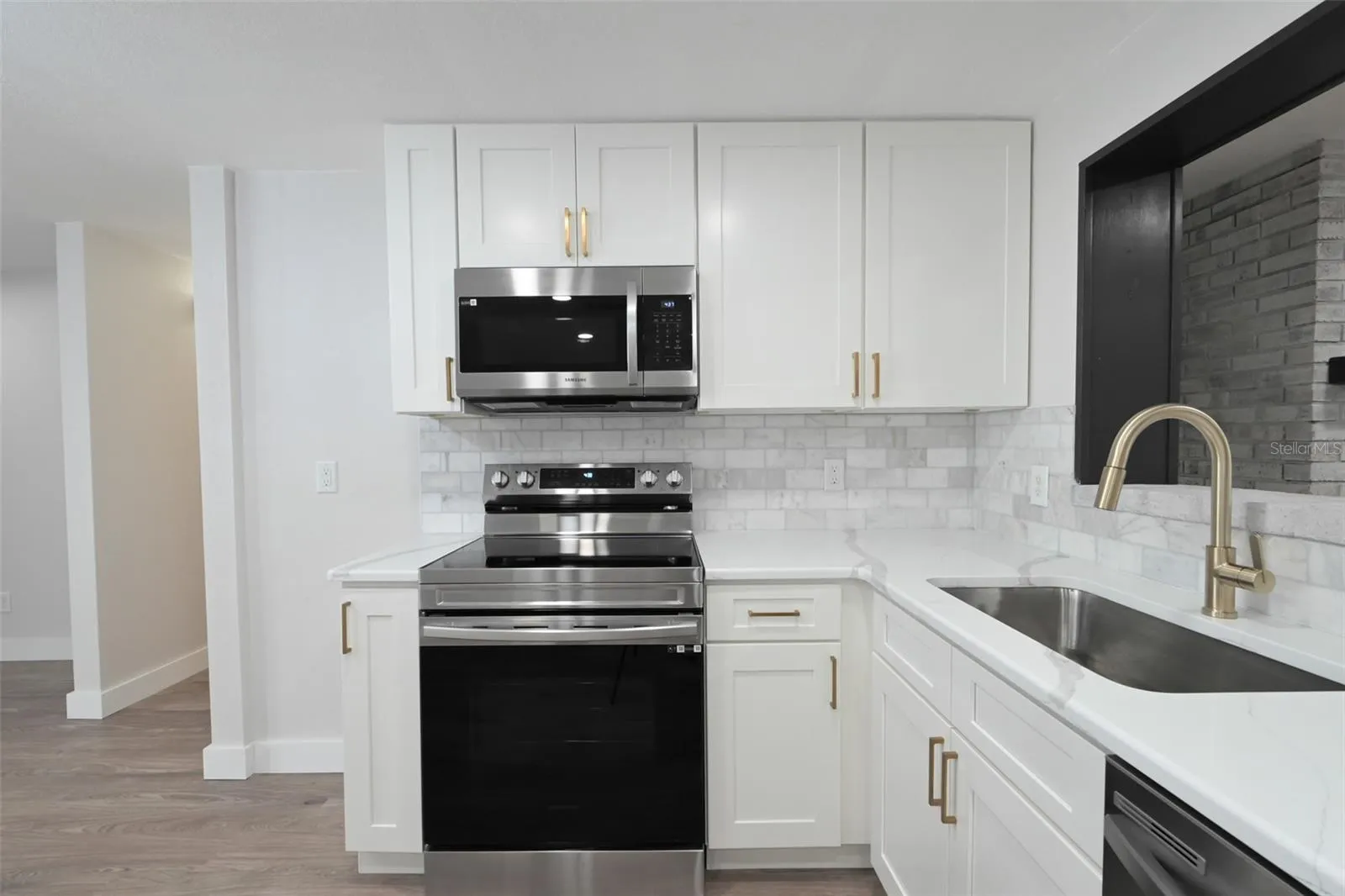 Stove &amp; Microwave. You can see the fireplace through kitchen open window.