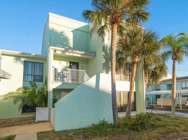 Ground floor end unit with private entry and covered parking spot.