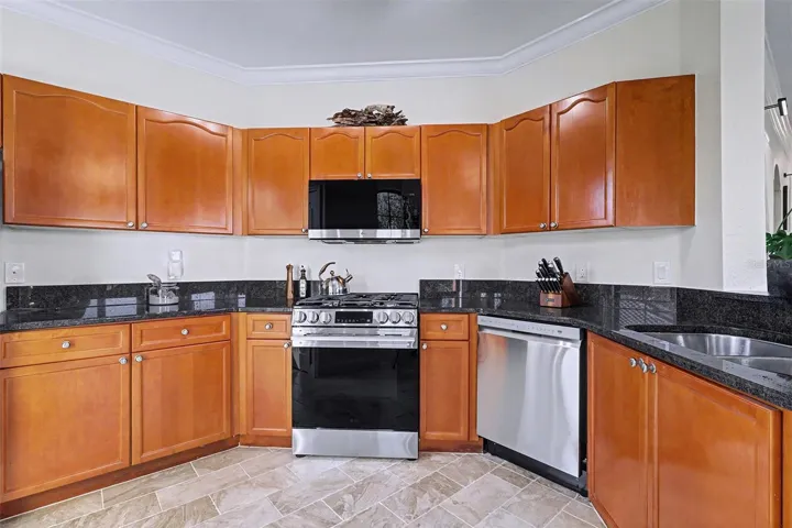 Open kitchen with granite counter tops, new stainless steel appliances