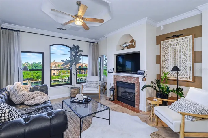 Designer's delight in this spacious living area with gas fireplace and multiple windows  overlooking the water