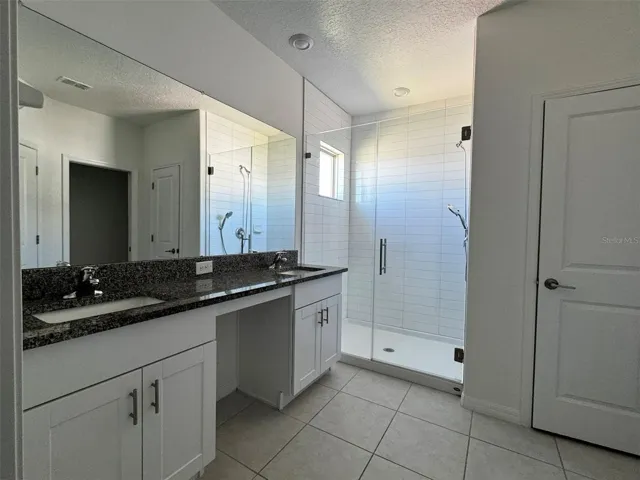 primary en suite bath with dual vanity