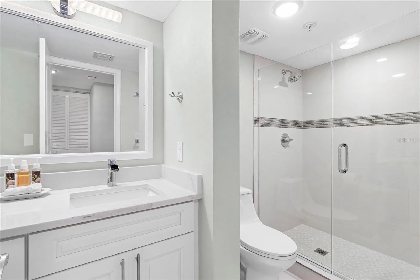 guest bathroom vanity and separate commode / shower area