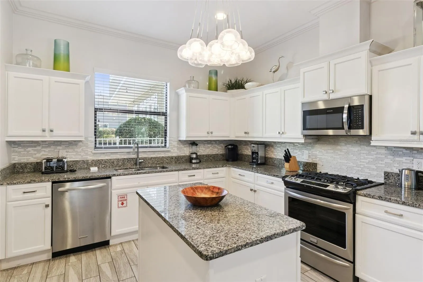 Beautiful modern kitchen with stainless steel appliances and gas stove.