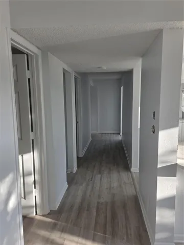 Hallway from the entrance to Living space and kitchen to the right