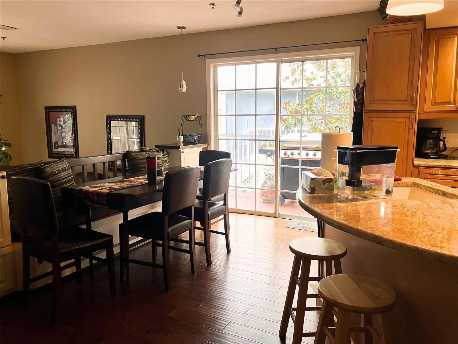 Sliding doors in kitchen lead out to side deck and area for BBQ grill.