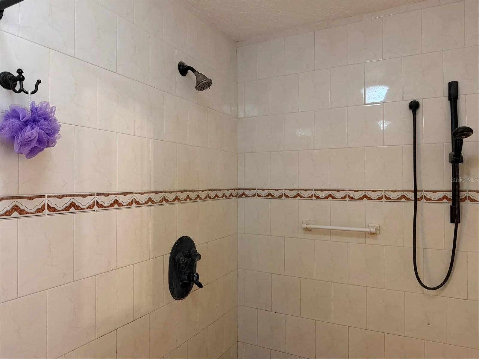 Large primary shower has multiple shower heads.