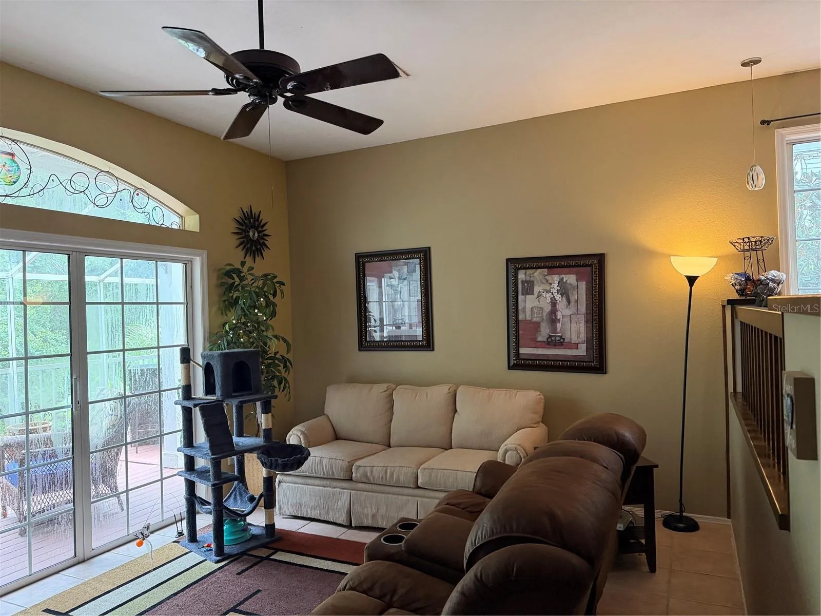 Sliding glass doors on main level lead to large screen enclosed balcony
