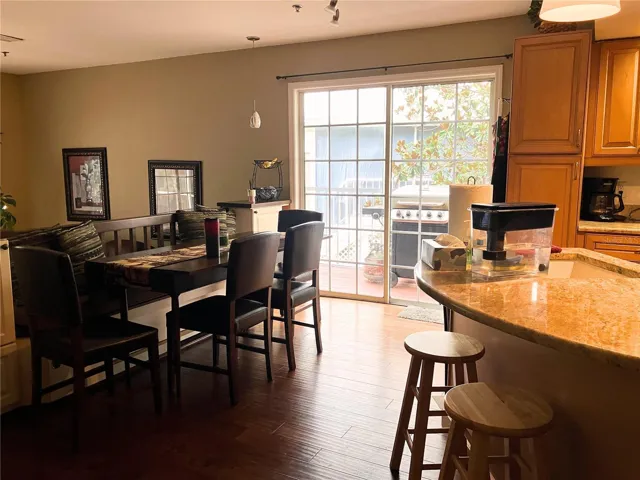 Sliding doors in kitchen lead out to side deck and area for BBQ grill.