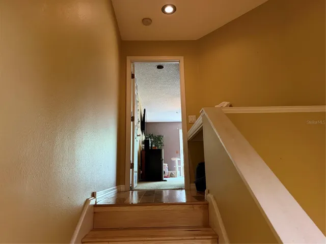 Stairs leading to primary bedroom suite