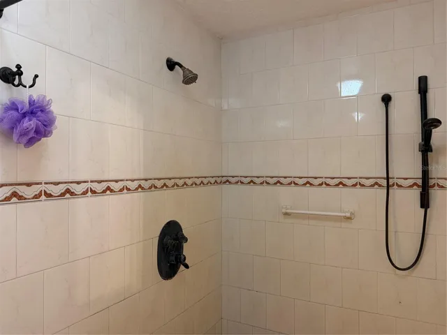 Large primary shower has multiple shower heads.