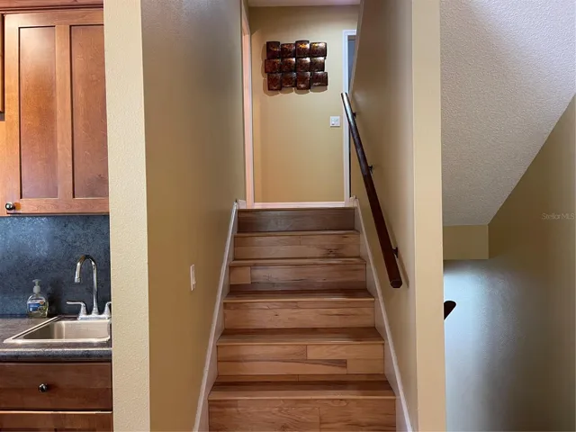 Stairs lead up to guest bathroom, and second and primary bedrooms.