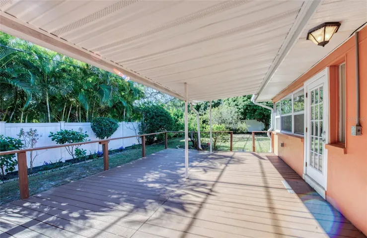 Covered porch overlooks backyard